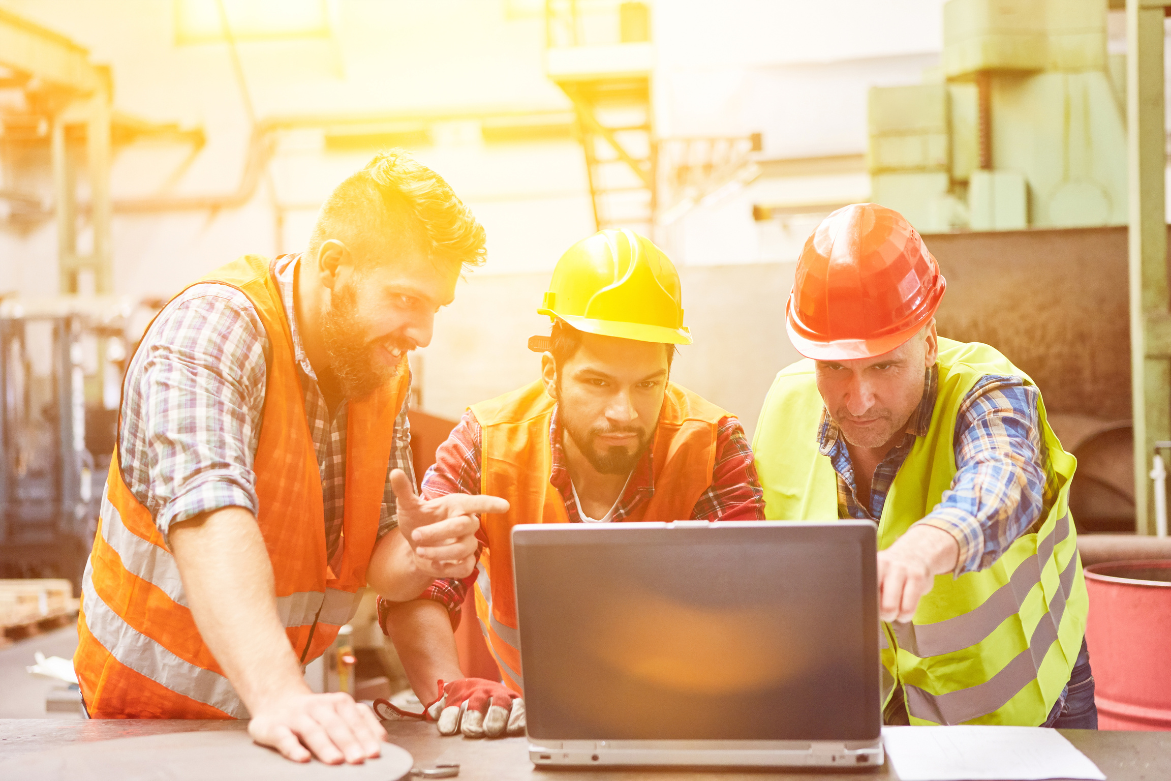 Metal Construction Workers Team at Laptop Computer